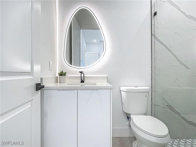 857 95th Ave N, Naples, FL 34108 - bathroom with toilet, vanity, tile patterned floors, and baseboards