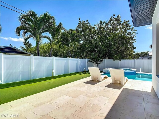 857 95th Ave N, Naples, FL 34108 - fenced backyard featuring a patio area and a pool with connected hot tub
