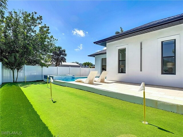 857 95th Ave N, Naples, FL 34108 - fenced backyard featuring a putting green and a patio