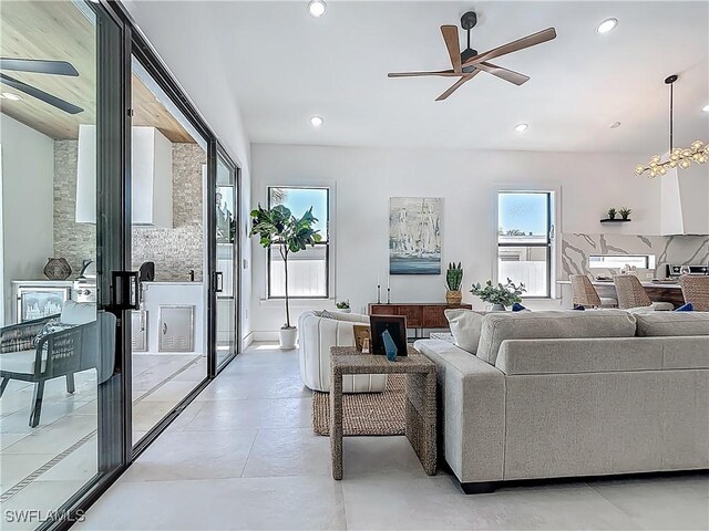 857 95th Ave N, Naples, FL 34108 - living room with ceiling fan, recessed lighting, and a chandelier