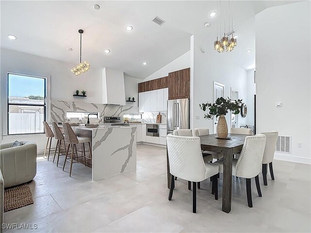 857 95th Ave N, Naples, FL 34108 - dining area with a chandelier, recessed lighting, and high vaulted ceiling