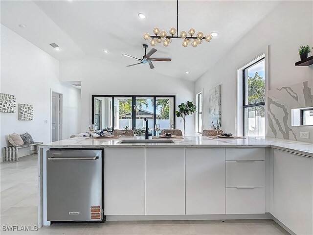 857 95th Ave N, Naples, FL 34108 - kitchen featuring a sink, modern cabinets, vaulted ceiling, a ceiling fan, and stainless steel dishwasher