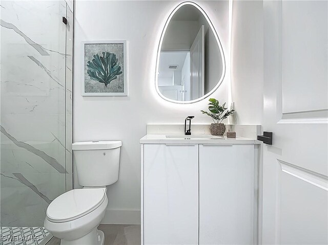 857 95th Ave N, Naples, FL 34108 - full bath with toilet, vanity, baseboards, and a marble finish shower