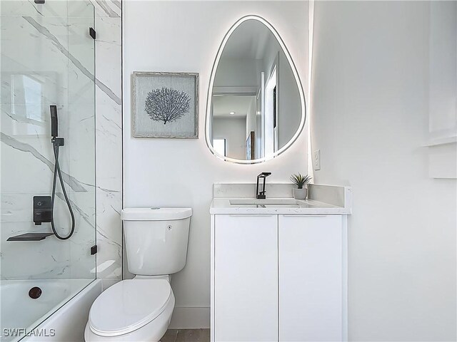 857 95th Ave N, Naples, FL 34108 - full bathroom with toilet, washtub / shower combination, vanity, and baseboards