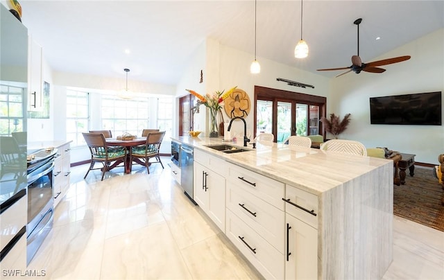 2535 River Reach Dr, Naples, FL 34104 - kitchen featuring a sink, healthy amount of natural light, light stone countertops, stainless steel appliances, and lofted ceiling