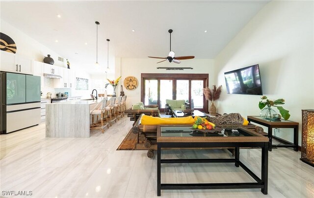 2535 River Reach Dr, Naples, FL 34104 - living area featuring a ceiling fan and high vaulted ceiling
