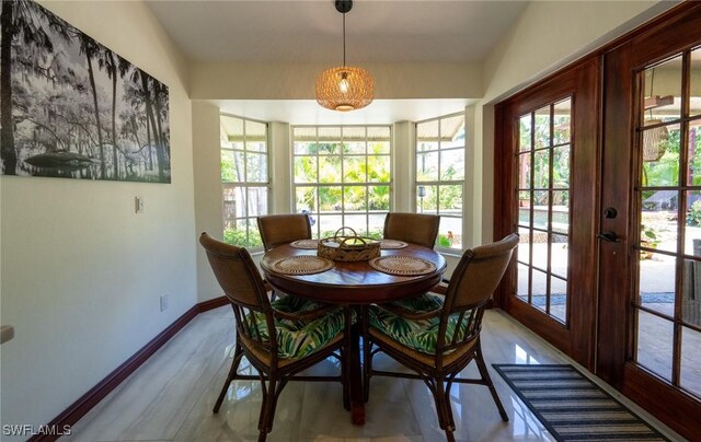 2535 River Reach Dr, Naples, FL 34104 - dining area with baseboards, french doors, and wood finished floors