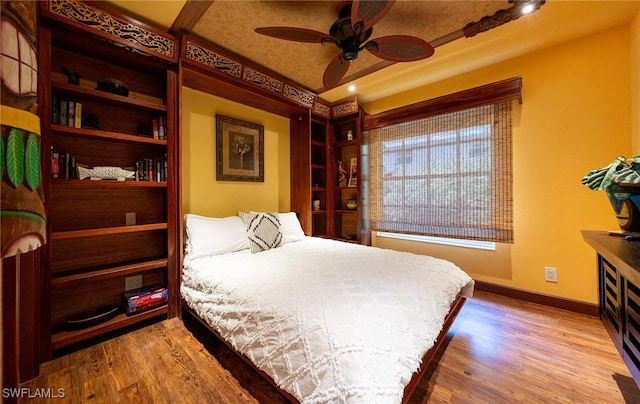 2535 River Reach Dr, Naples, FL 34104 - bedroom featuring baseboards, wood finished floors, and ceiling fan