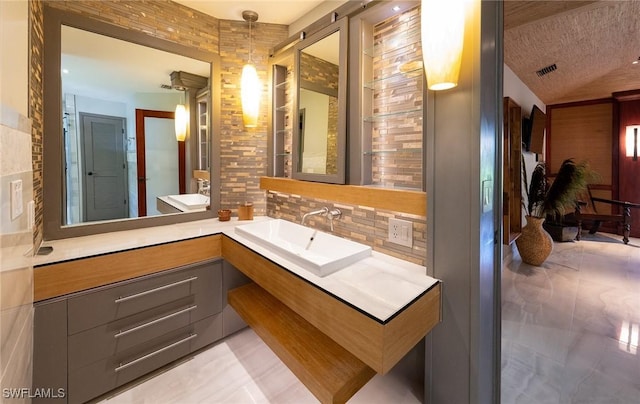 2535 River Reach Dr, Naples, FL 34104 - bathroom with tasteful backsplash, vanity, and vaulted ceiling