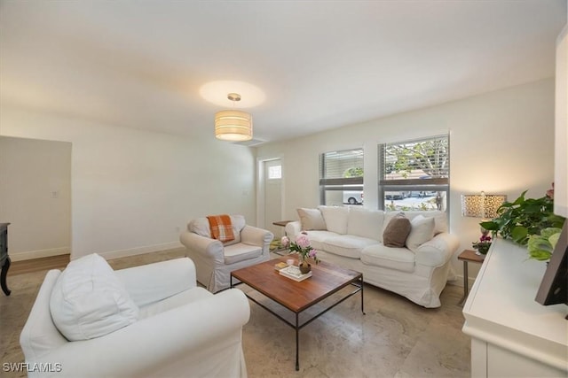 2777 Clipper Way, Naples, FL 34104 - living room featuring plenty of natural light and baseboards