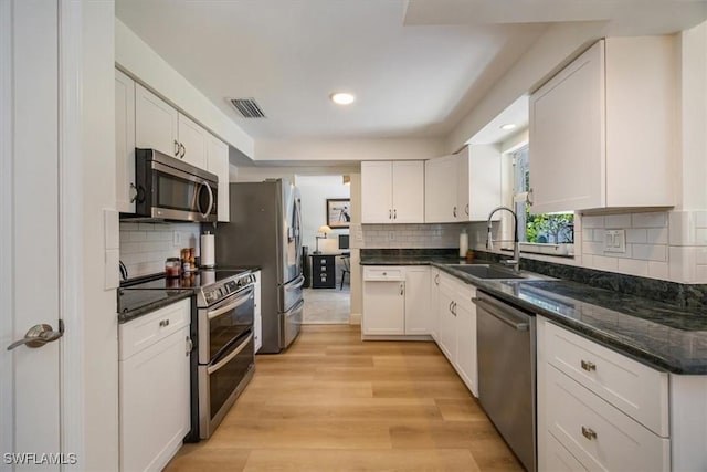 2777 Clipper Way, Naples, FL 34104 - kitchen with appliances with stainless steel finishes, a sink, white cabinetry, decorative backsplash, and recessed lighting
