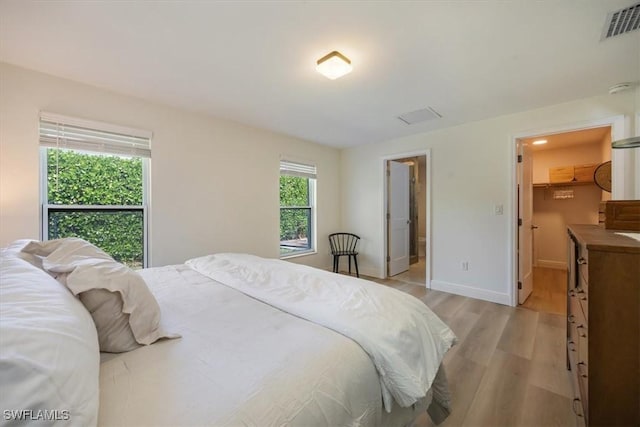 2777 Clipper Way, Naples, FL 34104 - bedroom with light wood finished floors, baseboards, and a walk in closet