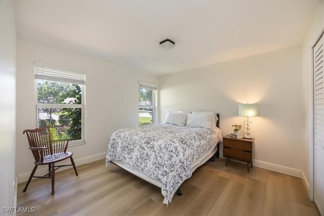2777 Clipper Way, Naples, FL 34104 - bedroom with baseboards and light wood-style flooring