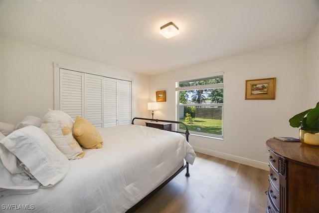 2777 Clipper Way, Naples, FL 34104 - bedroom featuring wood finished floors, baseboards, and a closet