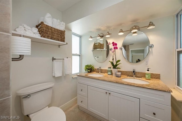 2777 Clipper Way, Naples, FL 34104 - bathroom with toilet, double vanity, and baseboards