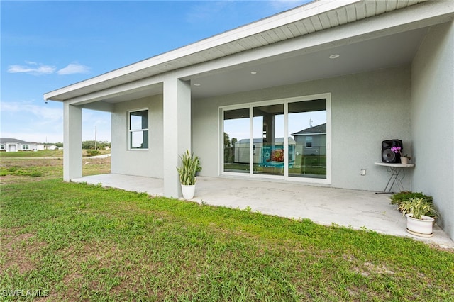 1049 Solar Ct, Labelle, FL 33935 - rear view of property featuring stucco siding and a lawn