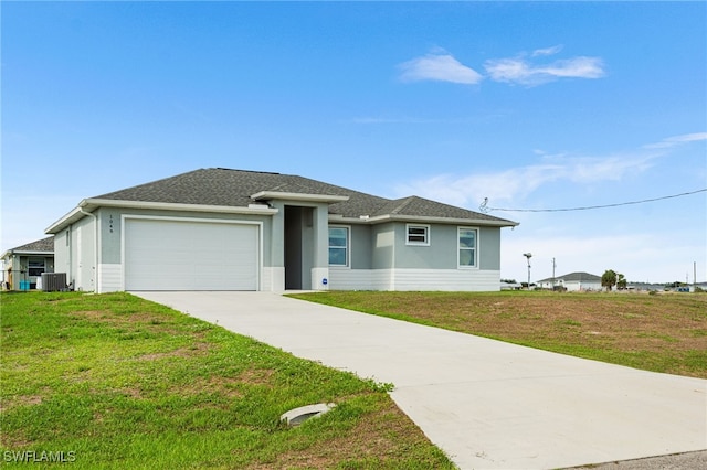 1049 Solar Ct, Labelle, FL 33935 - view of front facade with an attached garage, central air condition unit, concrete driveway, and a front lawn