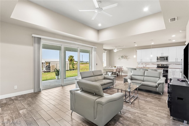 1049 Solar Ct, Labelle, FL 33935 - living area featuring a ceiling fan, light wood-style floors, a raised ceiling, baseboards, and recessed lighting