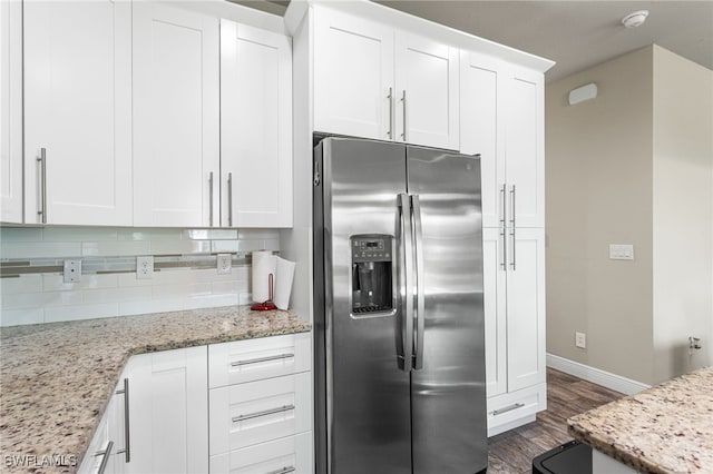 1049 Solar Ct, Labelle, FL 33935 - kitchen featuring stainless steel refrigerator with ice dispenser, dark wood-style flooring, baseboards, backsplash, and white cabinetry