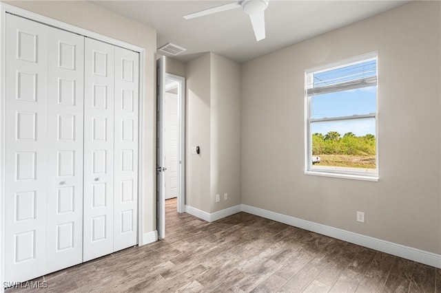 1049 Solar Ct, Labelle, FL 33935 - unfurnished bedroom featuring a closet, wood finished floors, baseboards, and a ceiling fan