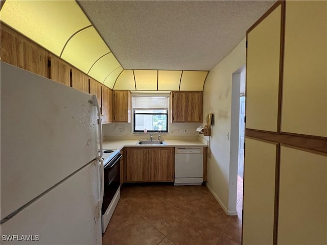 4186 27th Ct SW Unit 105, Naples, FL 34116 - kitchen with white appliances, a sink, light countertops, dark tile patterned flooring, and a textured ceiling