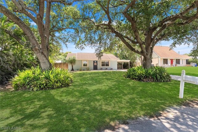 7709 1st Ter, Lake Worth, FL 33463 - view of front of home with a carport and stucco siding