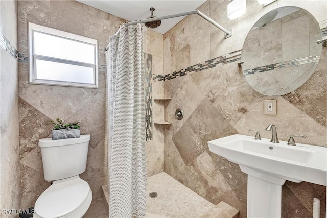 7709 1st Ter, Lake Worth, FL 33463 - bathroom featuring tile walls, toilet, a tile shower, and a sink
