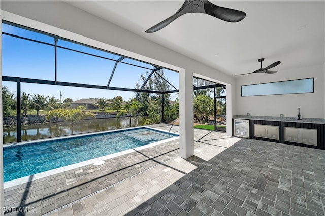419 NW 7th Ave, Cape Coral, FL 33993 - outdoor pool featuring an outdoor kitchen, a ceiling fan, a patio, a water view, and glass enclosure