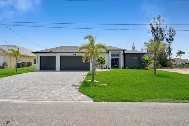 419 NW 7th Ave, Cape Coral, FL 33993 - single story home with decorative driveway, a front lawn, and a garage
