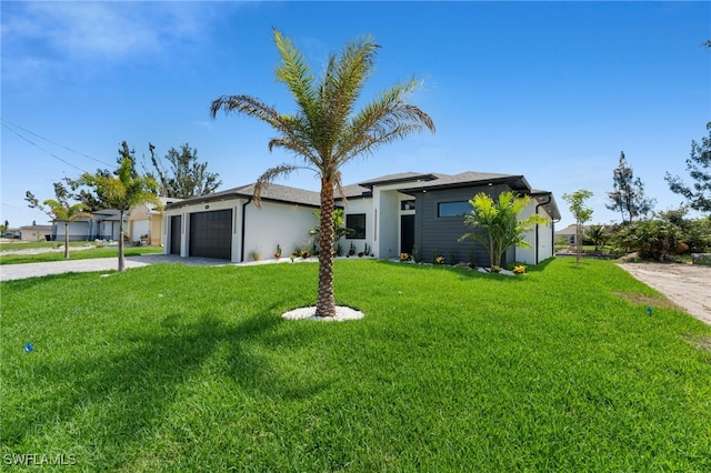 419 NW 7th Ave, Cape Coral, FL 33993 - view of front of house with an attached garage, driveway, a front yard, and stucco siding