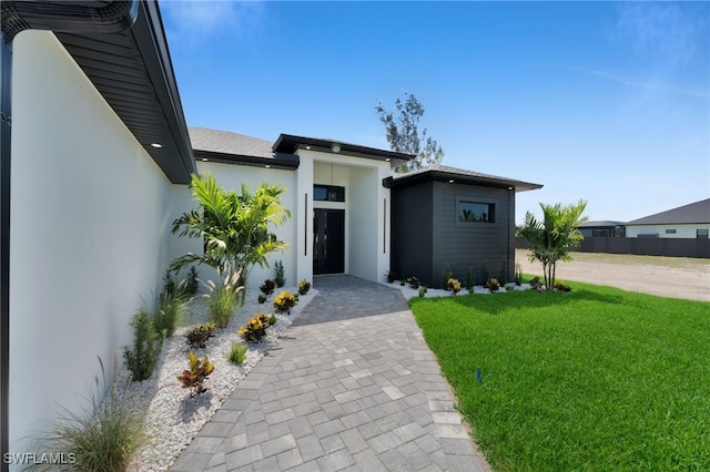 419 NW 7th Ave, Cape Coral, FL 33993 - modern home with stucco siding and a front yard