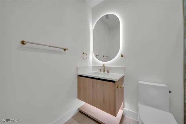 419 NW 7th Ave, Cape Coral, FL 33993 - bathroom with toilet, vanity, and baseboards