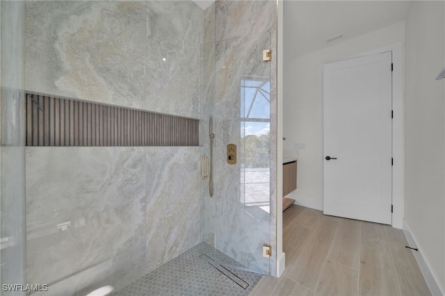 419 NW 7th Ave, Cape Coral, FL 33993 - bathroom featuring a shower stall, wood finished floors, and baseboards