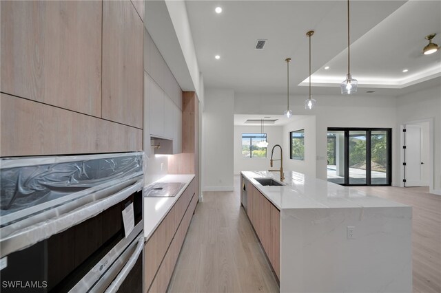 419 NW 7th Ave, Cape Coral, FL 33993 - kitchen with modern cabinets, a sink, light brown cabinetry, recessed lighting, and stainless steel oven