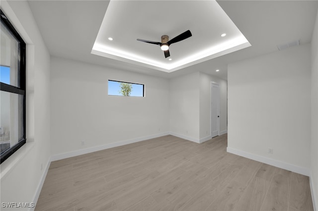 419 NW 7th Ave, Cape Coral, FL 33993 - empty room with recessed lighting, a tray ceiling, ceiling fan, light wood-style floors, and baseboards