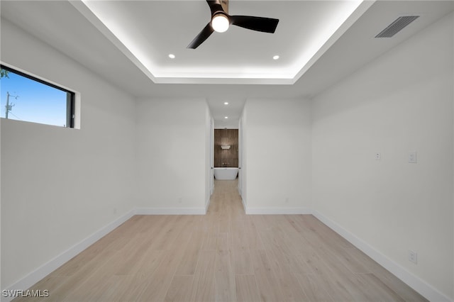 419 NW 7th Ave, Cape Coral, FL 33993 - unfurnished room with a ceiling fan, a raised ceiling, recessed lighting, light wood finished floors, and baseboards
