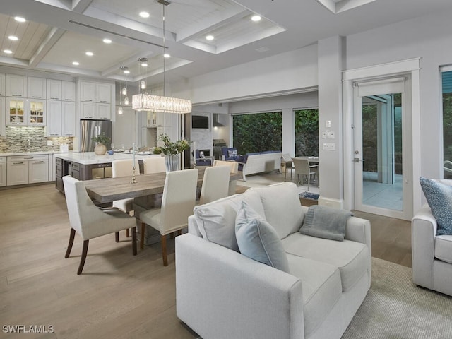 242 2nd Ave S, Naples, FL 34102 - living area with coffered ceiling, light wood-style flooring, beam ceiling, and recessed lighting
