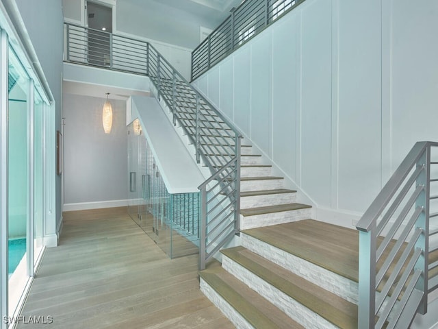 242 2nd Ave S, Naples, FL 34102 - staircase with hardwood / wood-style floors and baseboards