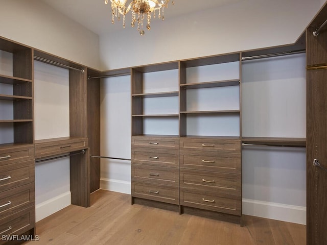 242 2nd Ave S, Naples, FL 34102 - spacious closet featuring a chandelier and light wood finished floors