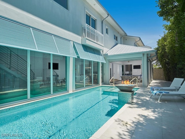 242 2nd Ave S, Naples, FL 34102 - swimming pool featuring an outdoor fire pit and a patio