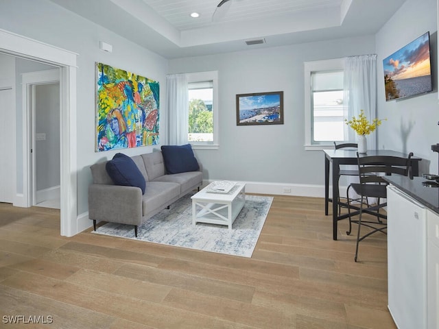 242 2nd Ave S, Naples, FL 34102 - living area featuring a raised ceiling, light wood-style flooring, baseboards, and recessed lighting