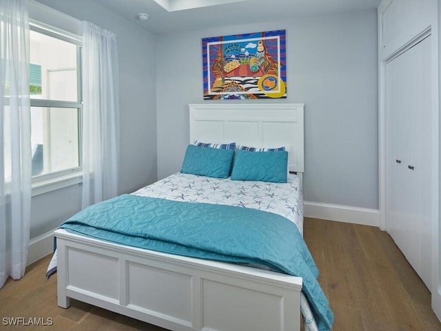 242 2nd Ave S, Naples, FL 34102 - bedroom with wood finished floors and baseboards