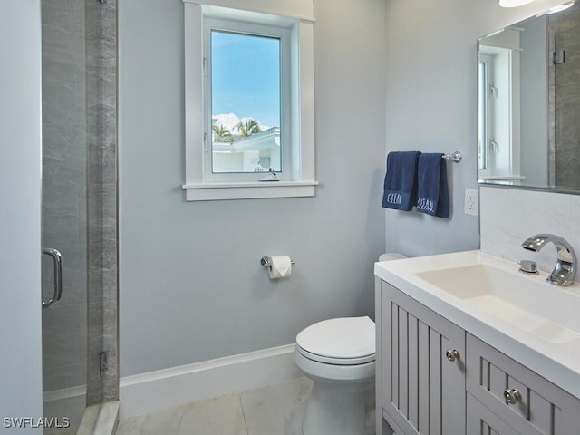 242 2nd Ave S, Naples, FL 34102 - full bathroom featuring toilet, marble look tiles, vanity, and a stall shower
