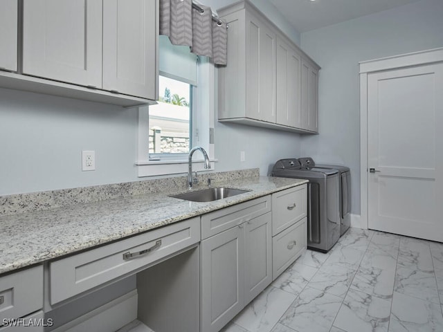 242 2nd Ave S, Naples, FL 34102 - laundry room with washer and clothes dryer, light marble finish floors, and cabinet space