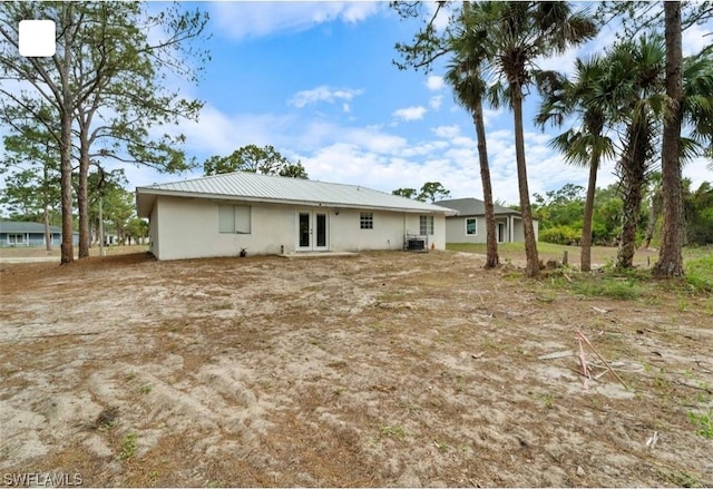 5005 Squaw Ln, Labelle, FL 33935 - back of property featuring stucco siding and french doors
