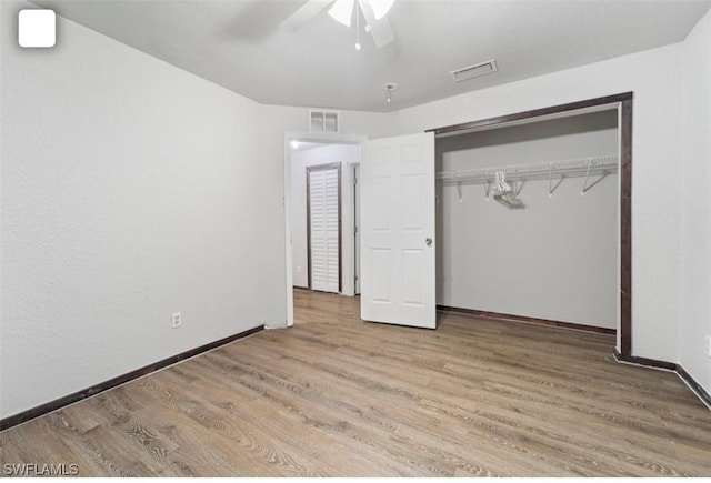 5005 Squaw Ln, Labelle, FL 33935 - unfurnished bedroom featuring wood finished floors, a closet, baseboards, and ceiling fan
