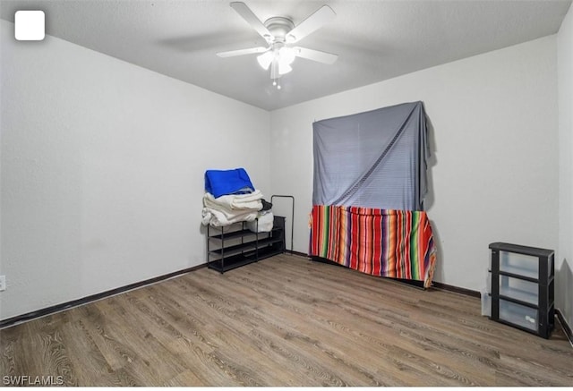 5005 Squaw Ln, Labelle, FL 33935 - empty room featuring wood finished floors, a ceiling fan, and baseboards