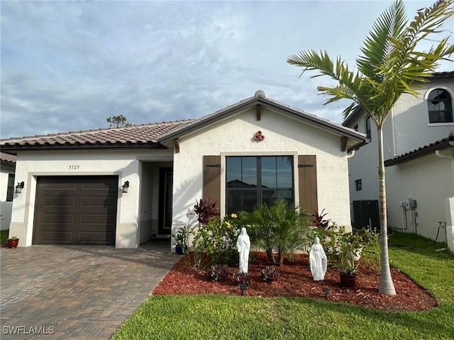 5725 Cassidy Ln, Ave Maria, FL 34142 - view of front of property with an attached garage, decorative driveway, stucco siding, and a tile roof