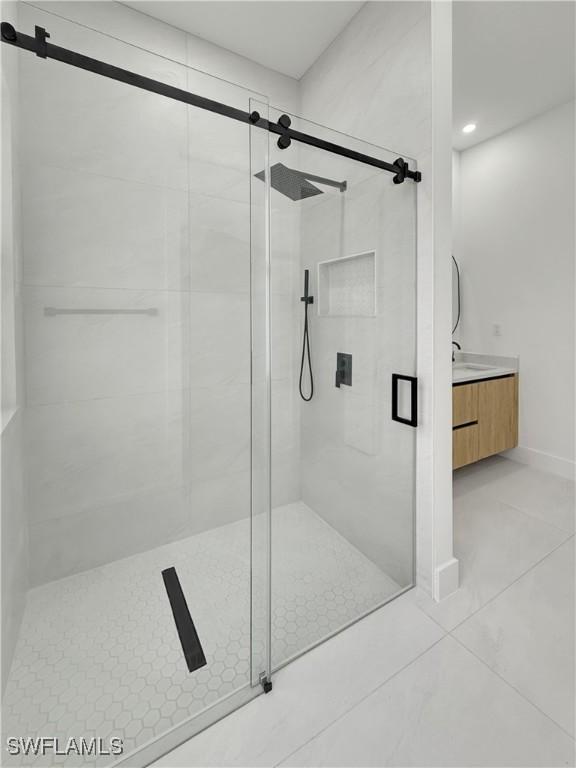 3247 72nd Ave NE, Naples, FL 34120 - bathroom with a shower stall, tile patterned flooring, recessed lighting, and vanity