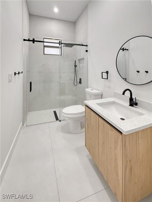3247 72nd Ave NE, Naples, FL 34120 - full bath featuring a shower stall, toilet, and vanity